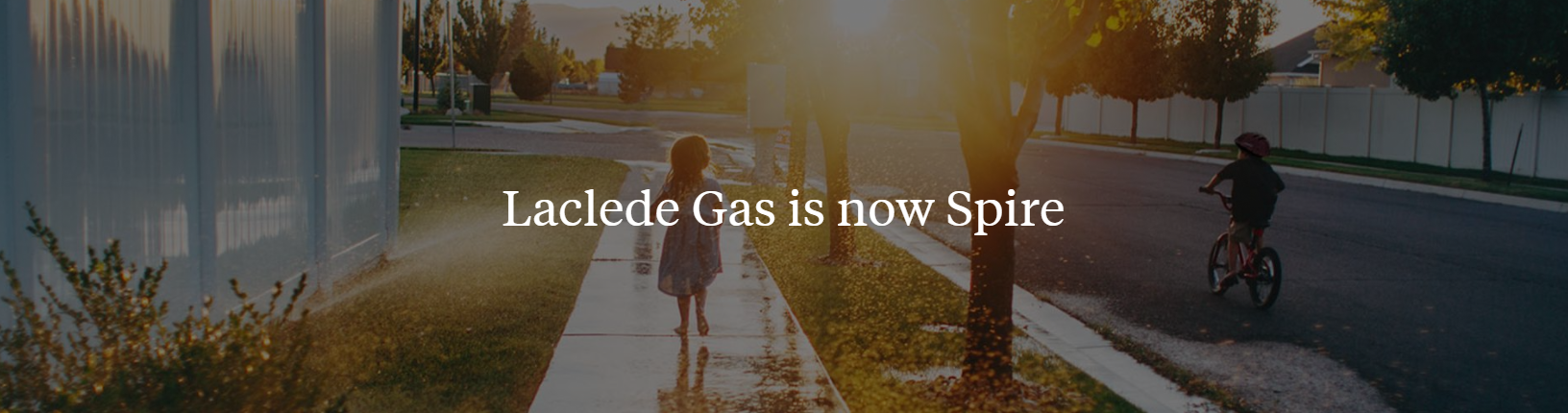 Image of girl and father walking with text overlay stating Laclede Gas is now Spire